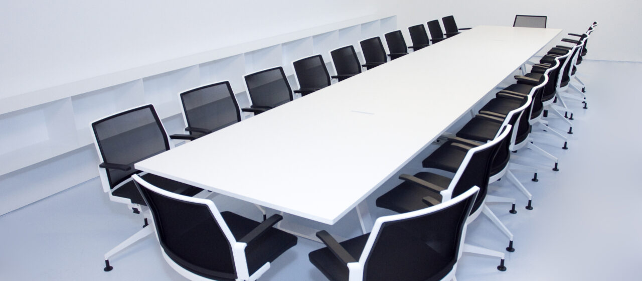 New seminar room, long white table with black chairs around it