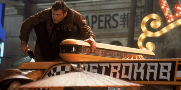 Harrison Ford climbing onto the top of a taxi cab