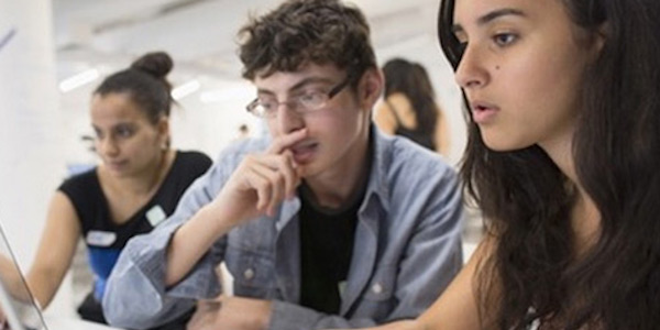 Two teenagers sitting at a desk