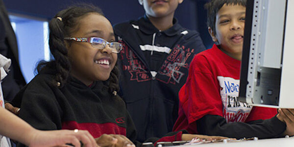 Kids in a workshop smiling