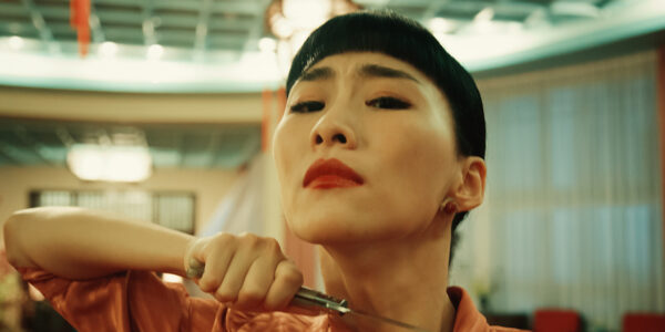 A woman holds a knife to her throat