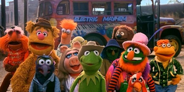 The whole Muppet gang, fronted by Kermit the Frog, facing the camera