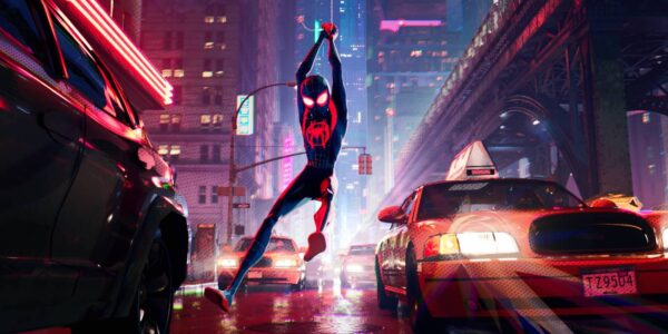 Spider-Man flies through a New York city street above taxicabs