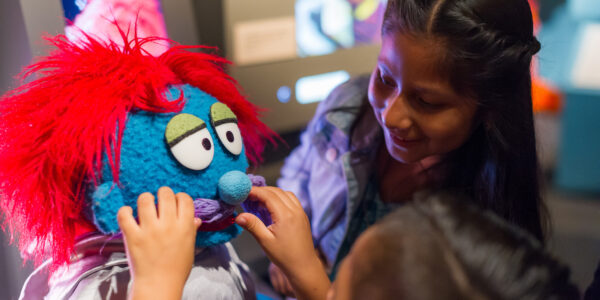 A kid designs a muppet at the interactive "Anything Muppet" station in The Jim Henson Exhibition at Museum of the Moving Image.
