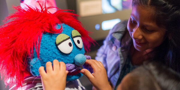 A kid designs a muppet at the interactive "Anything Muppet" station in The Jim Henson Exhibition at Museum of the Moving Image.