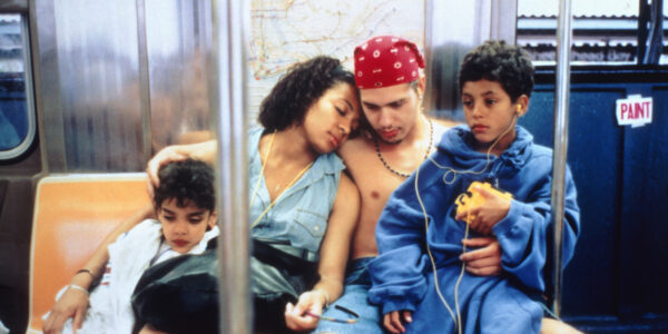 A husband and wife hold their two kids as they sit on the New York City subway