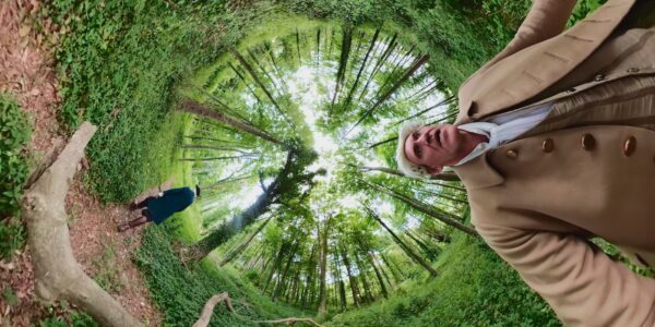 A fantasy spiral effect of an outdoor scene of two men in a green forest