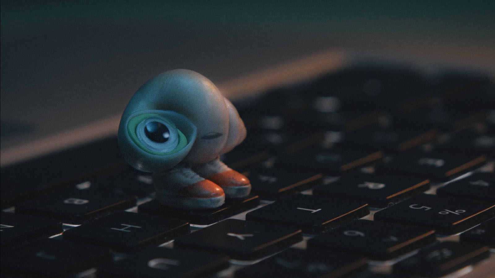 A tiny shell with shoes perches on a keyboard