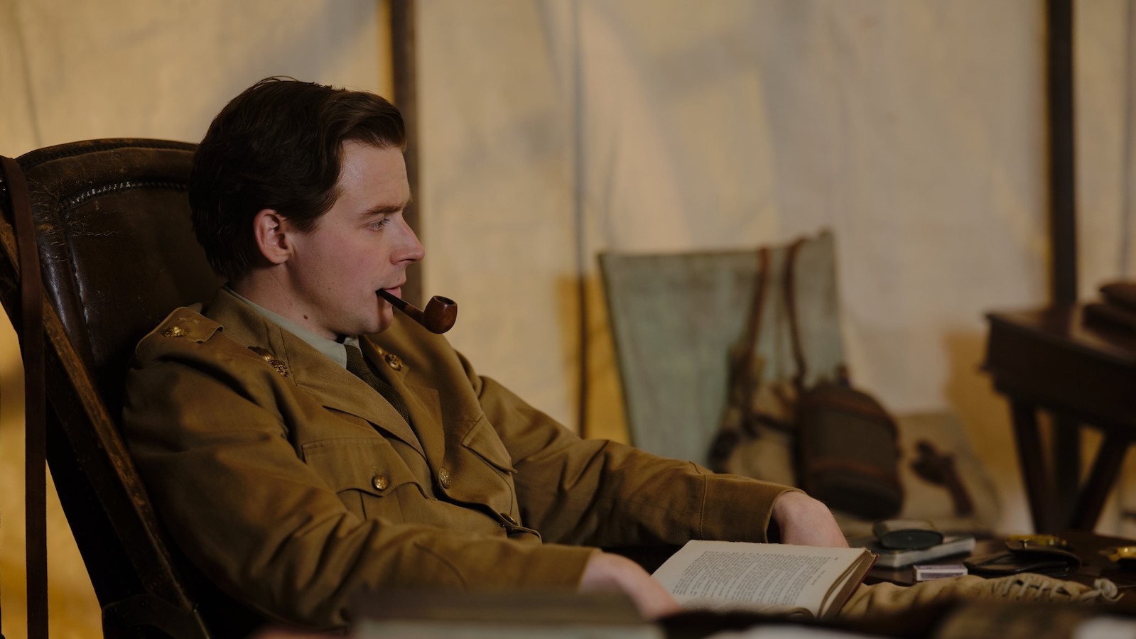 Benediction 1 A man sits in a tent smoking a pipe