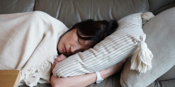 A woman sleeps on a couch