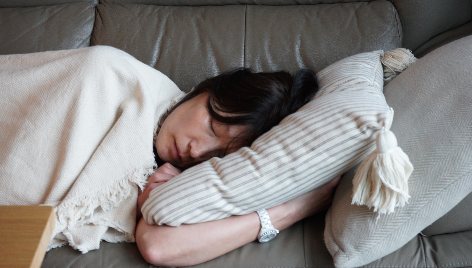A woman sleeps on a couch