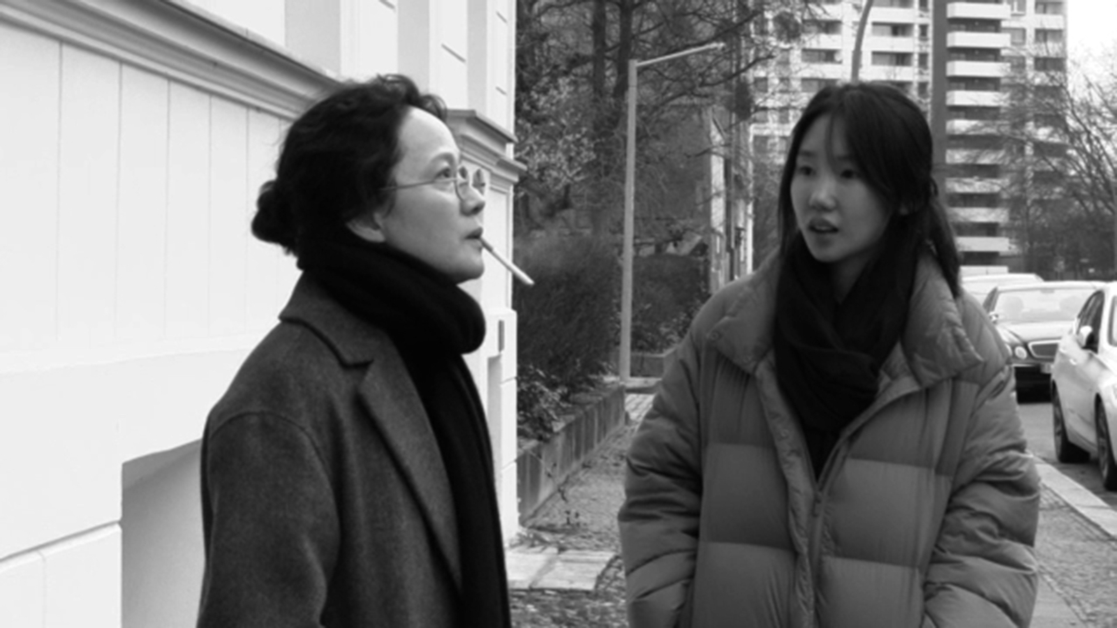 Two women in coats stand outside