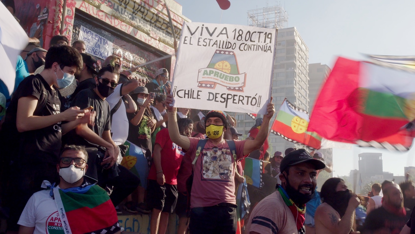 Protestors in the street holding signs in South America