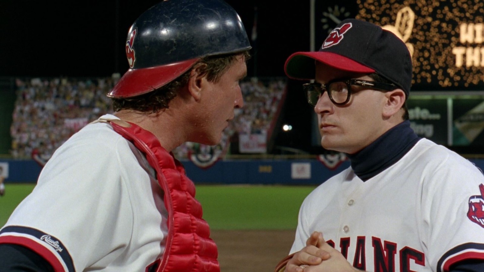 Two baseball players, a pitcher and a catcher for the Cleveland Indians, look intently at each other on the field