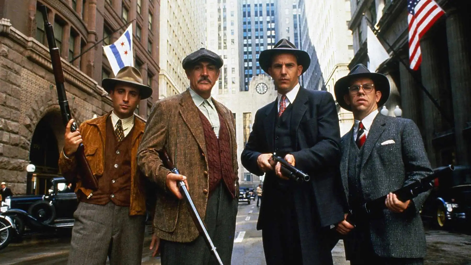 the-untouchables Four men in hats and 1920s garb hold shotguns and look at camera