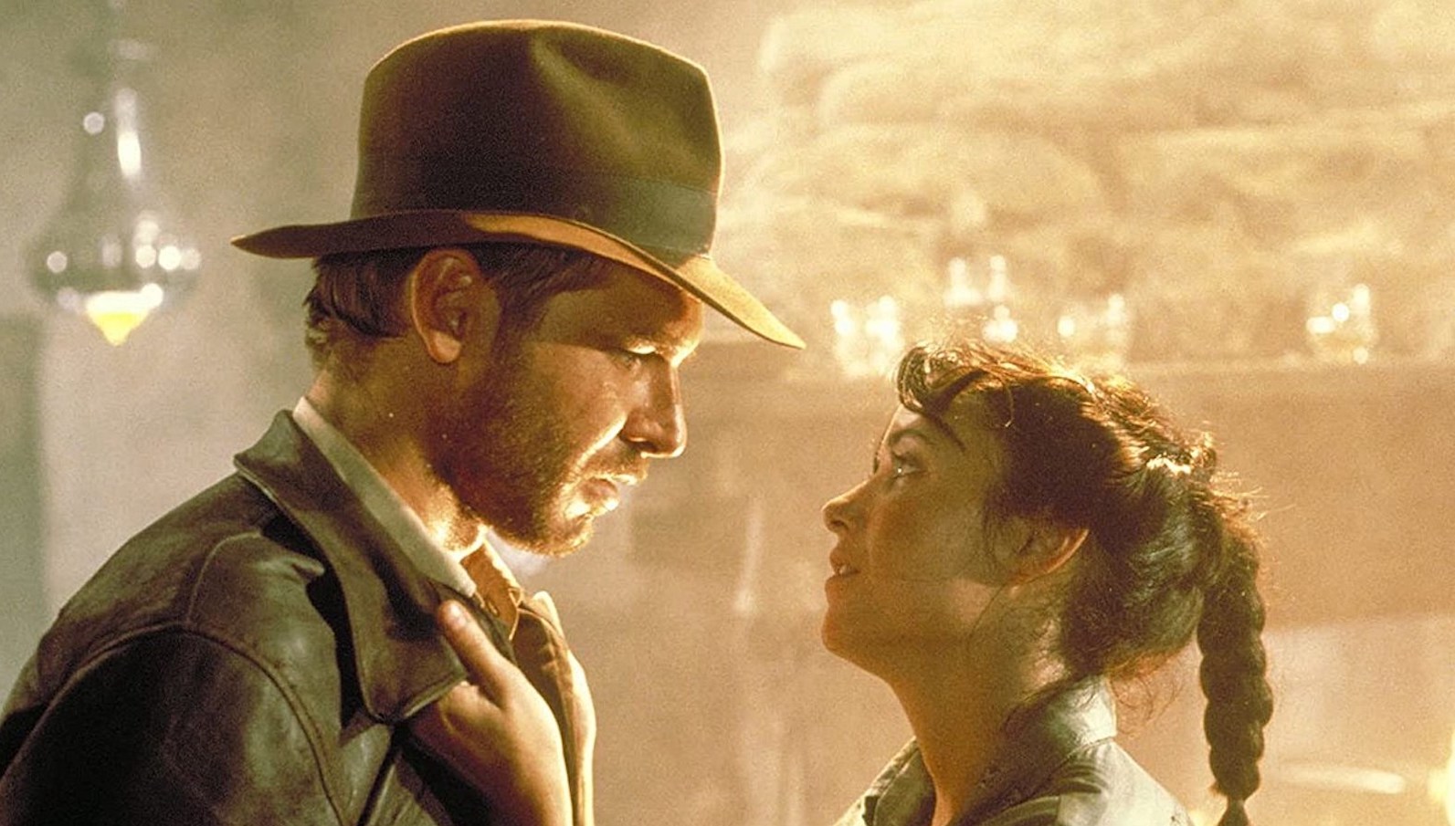 Raiders 1 A man and woman look at each other, she grabs his lapels