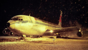 A jumbo airliner on the runway amidst snowfall