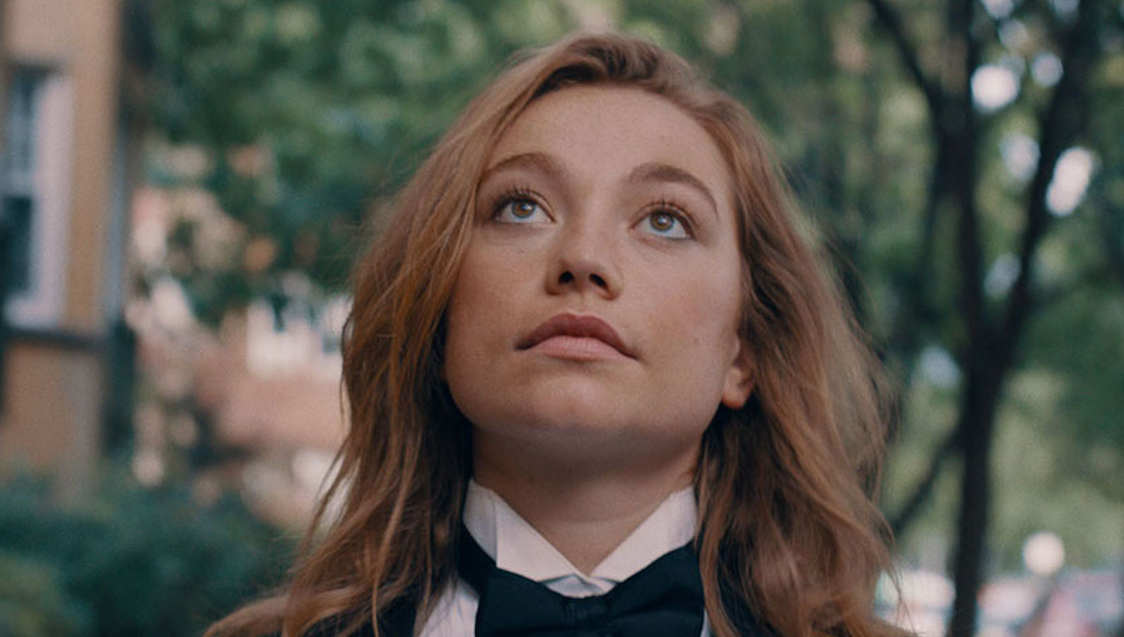 Princess-Cyd A girl with long red hair and wearing a tuxedo looks up