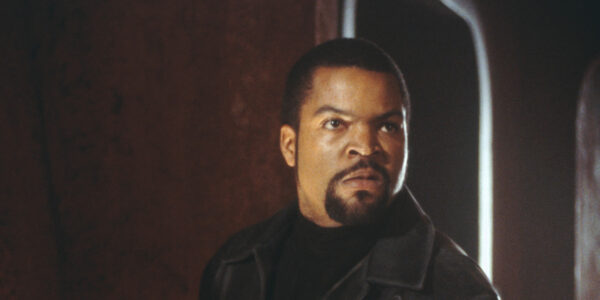 A man with a goatee looks angrily offscreen