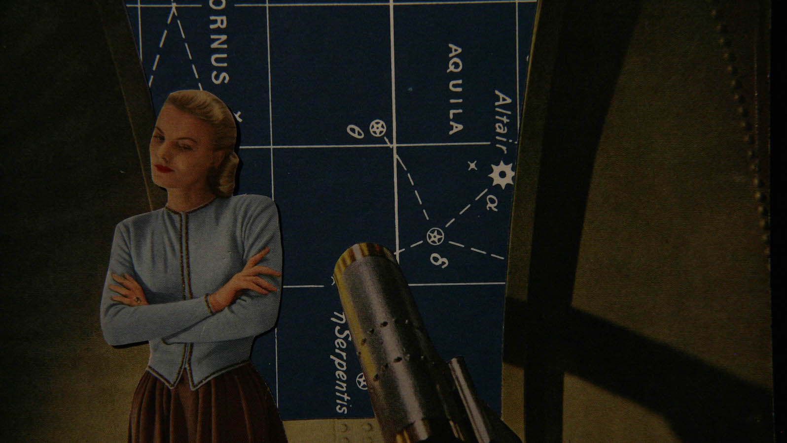 A cardboard cutout of a woman stands with her arms crossed against a diagram