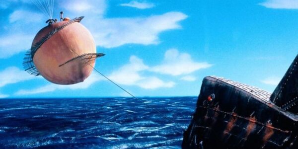 A giant peach floats in the sky over the sea connected to a rope tethered to a boat