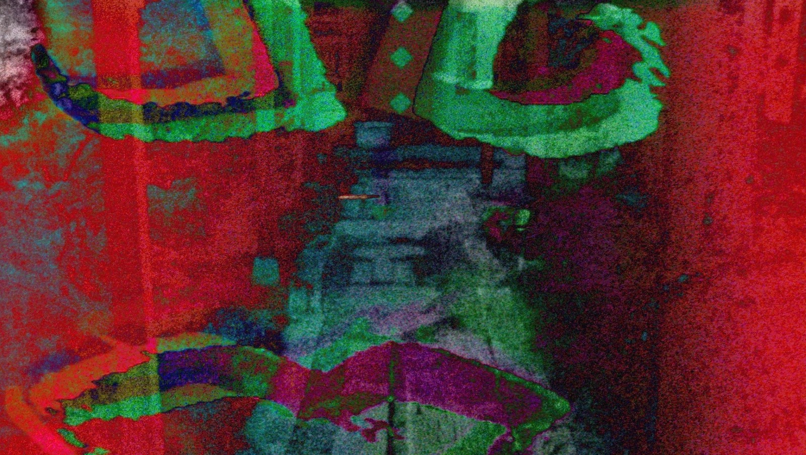 An abstract image of reds and greens with a hint of purple