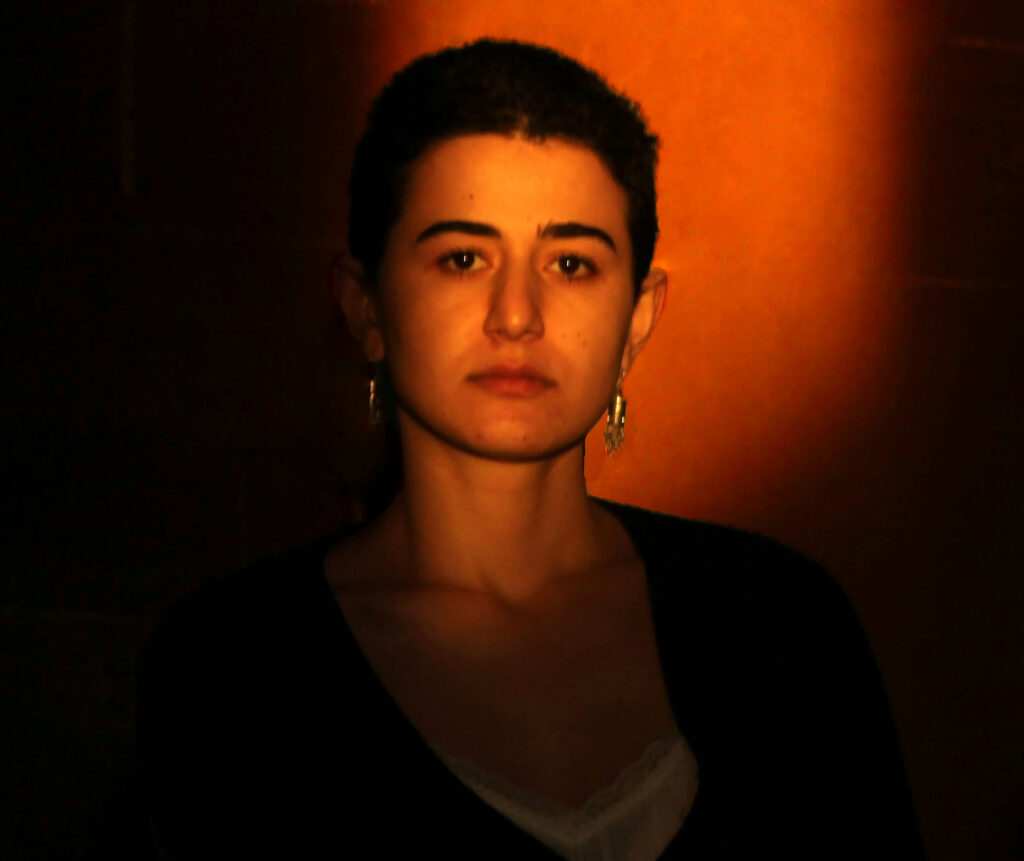 A close-up of a person with an orange glow.