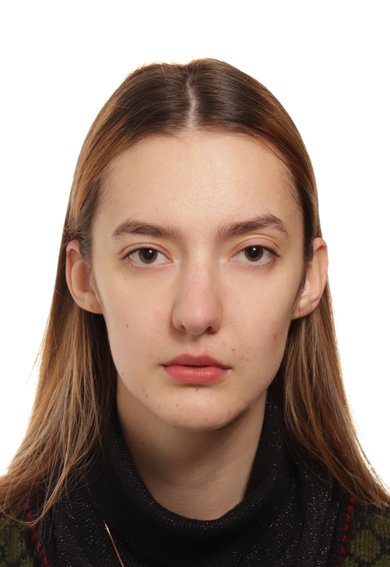 A woman with long hair looks in camera in close-up