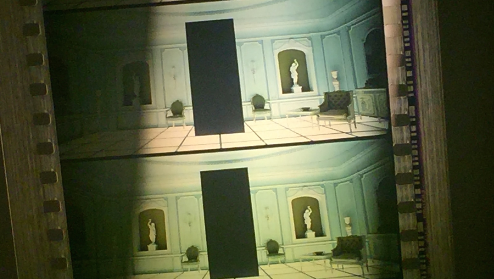 2001 70mm Two frames from the film 2001: A Space Odyssey showing the film projector sprockets on the side. The image is of a large black rectangle monolith standing straight in a white, ornate room with a glowing floor and statuaries on the walls.