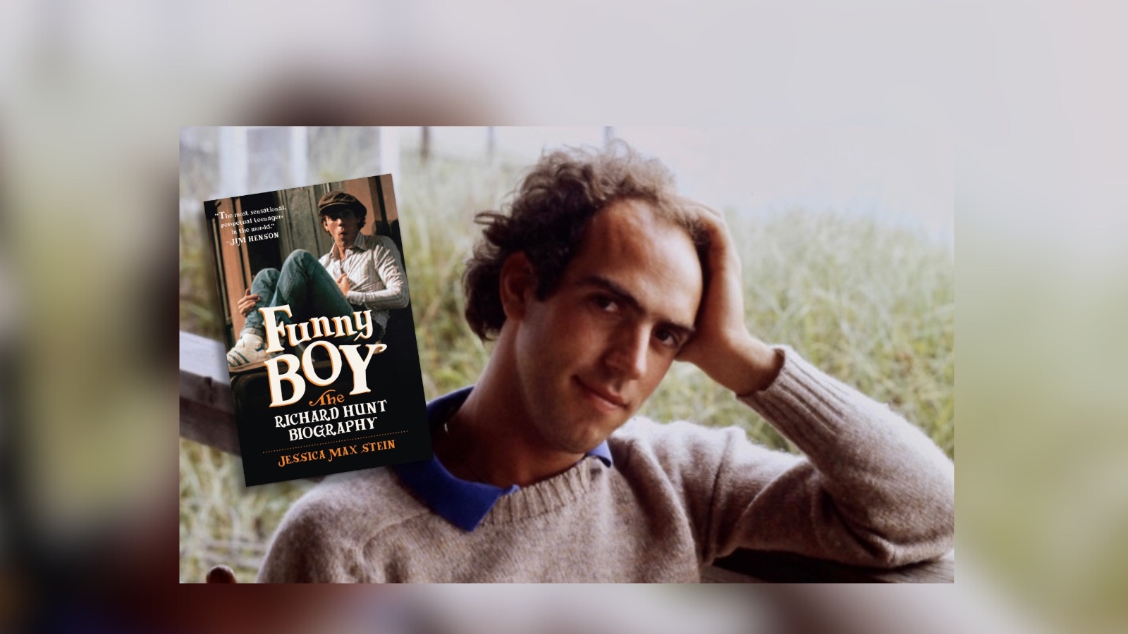 Richard Hunt web image A man with curly hair, a beige sweater and blue shirt underneath poking through the collar, sits with his hand propping up his head, smiling mildly. Next to him is a floating image of a book titled FUNNY BOY: THE RICHARD HUNT BIOGRAPHY