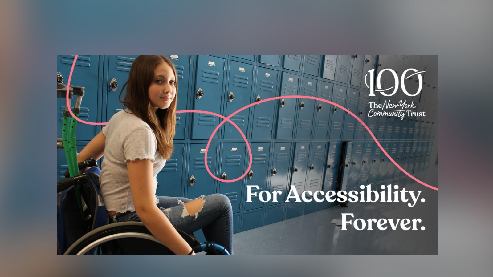 A teenage girl with long hair in a wheelchair, with crutches propped behind her in the back of the chair, turns and looks back at the camera as she passes a row of school lockers.